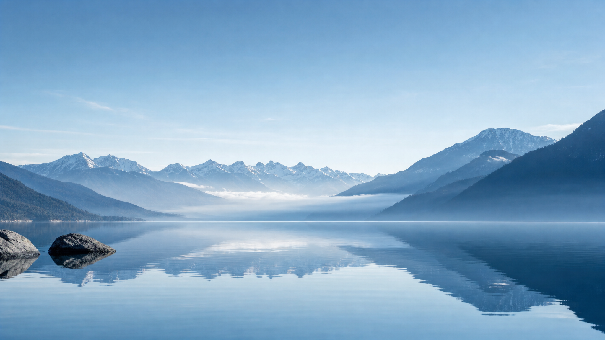 Mountain ridges emerging through soft morning mist